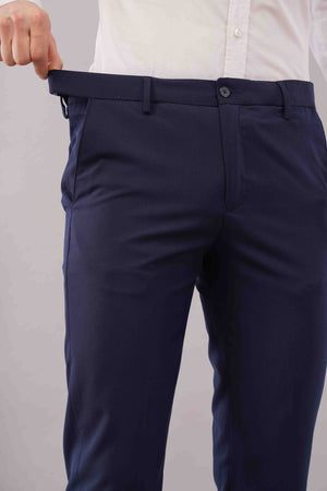 blue formal pants being worn on a plain background