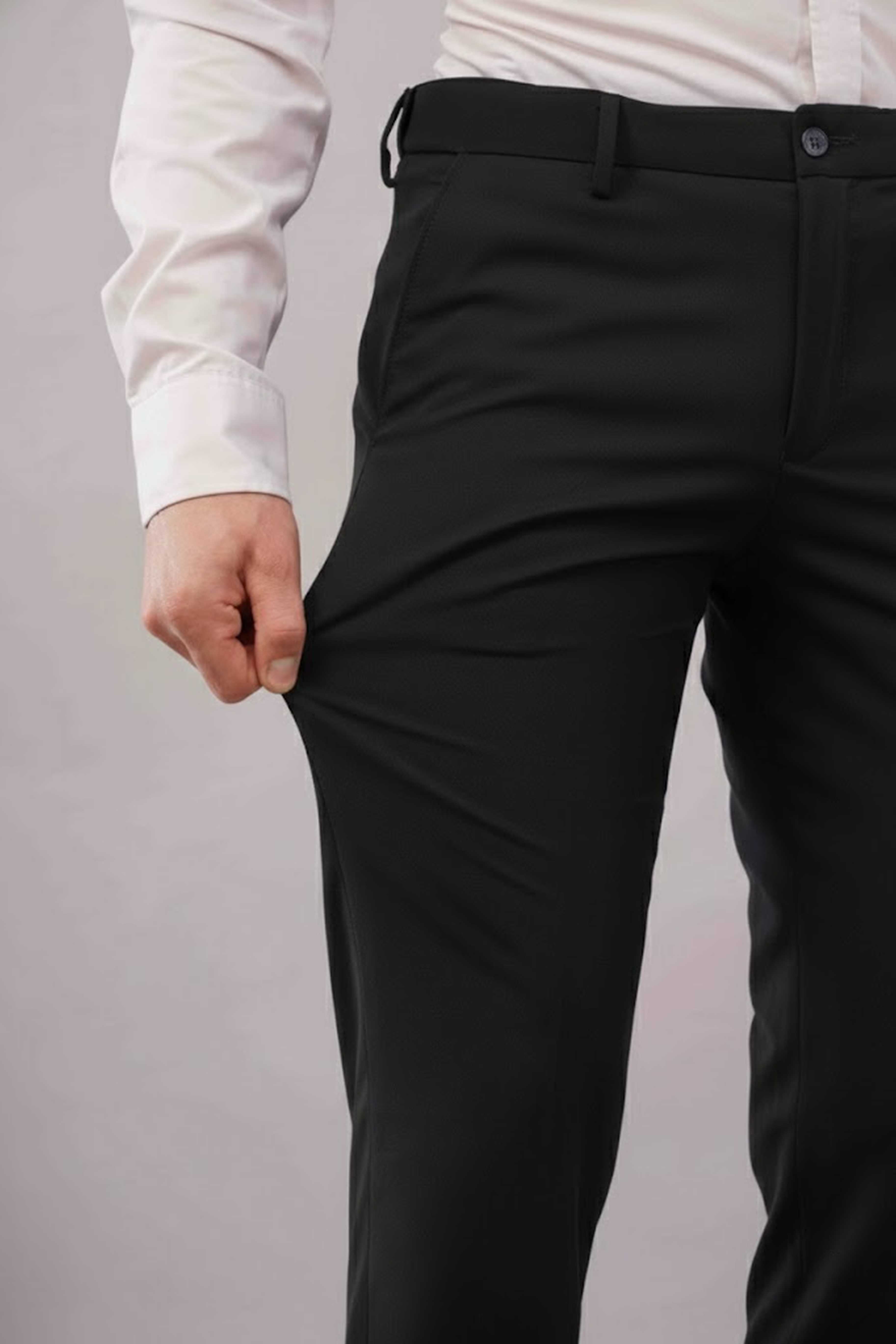 Person wearing 2-way stretch black pants and a white shirt 