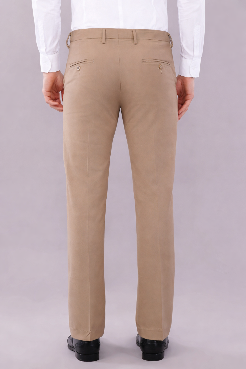 beige color stretchable pants worn by men with white color shirt