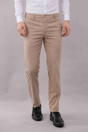 Person wearing 2 way lycra flexi stretch beige color pants and a white shirt