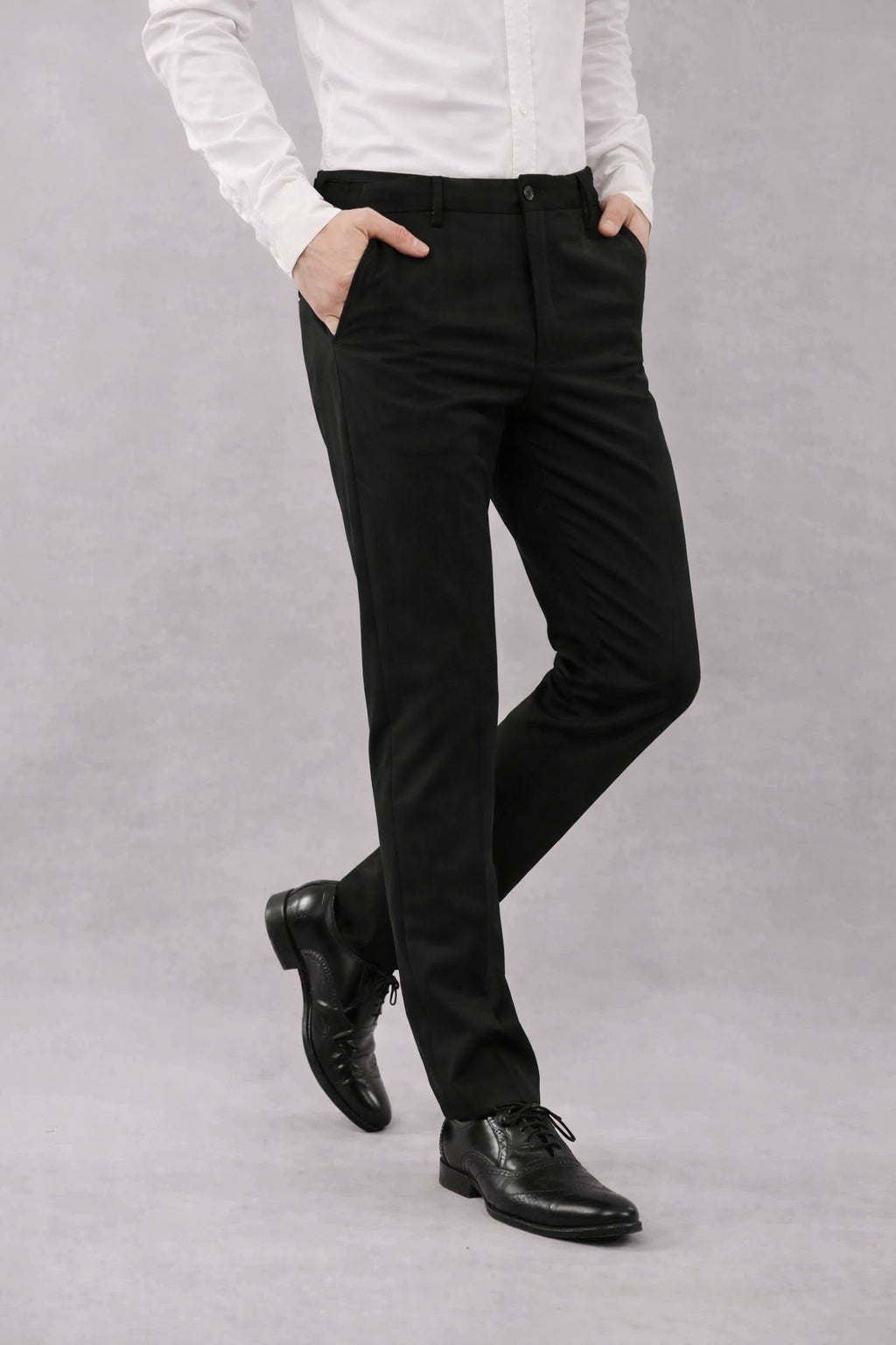 Person wearing a white shirt, black 4-way formal pants and black shoes