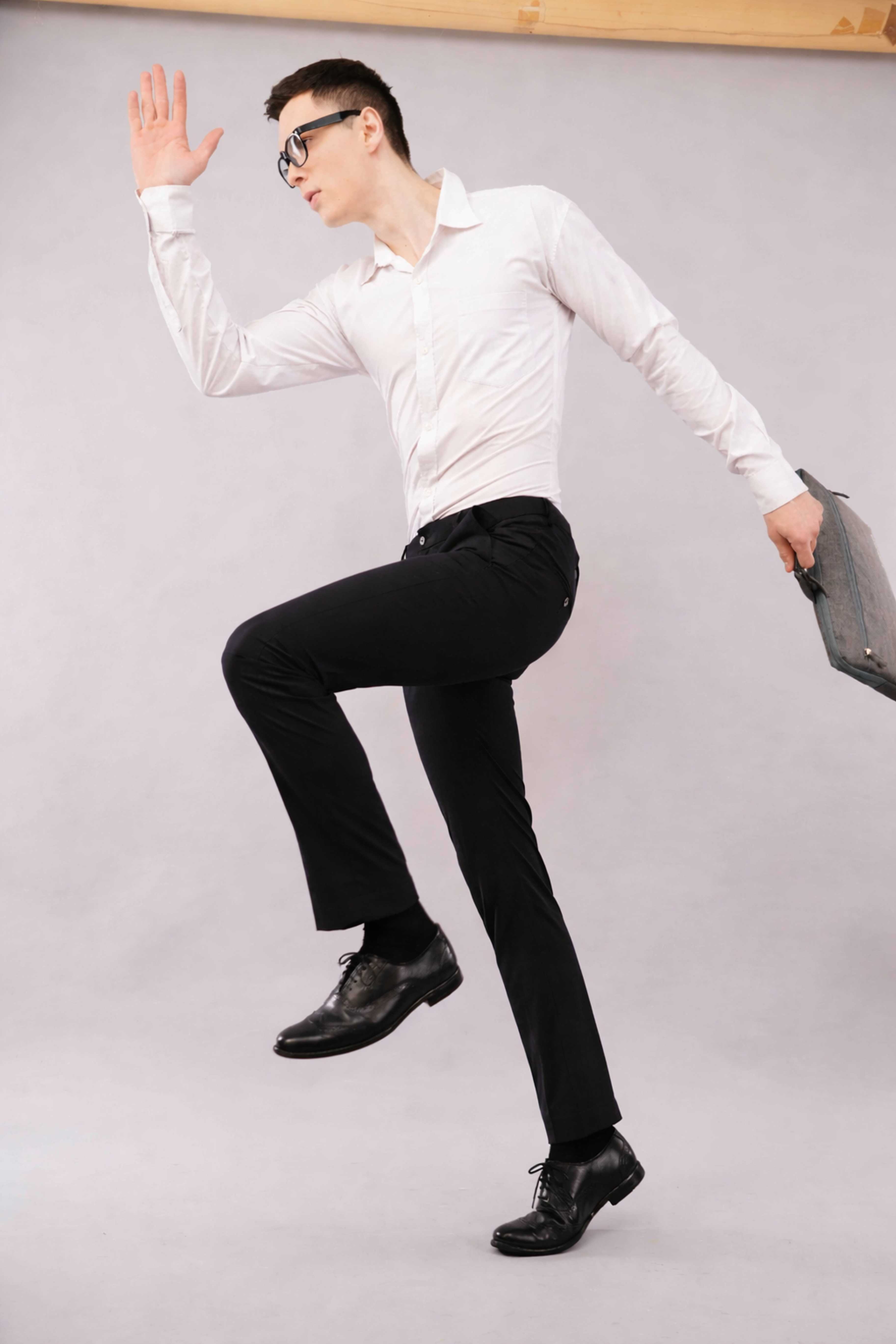 Person in 4 way flexi stretch pants posing with a briefcase