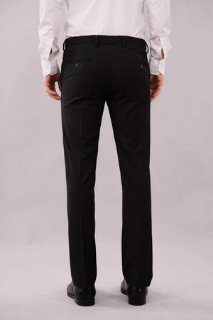 Person wearing black stretchable pants and a white shirt