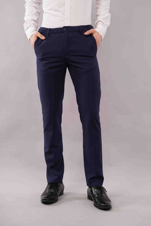 Person wearing blue pants and a white shirt on a grey background