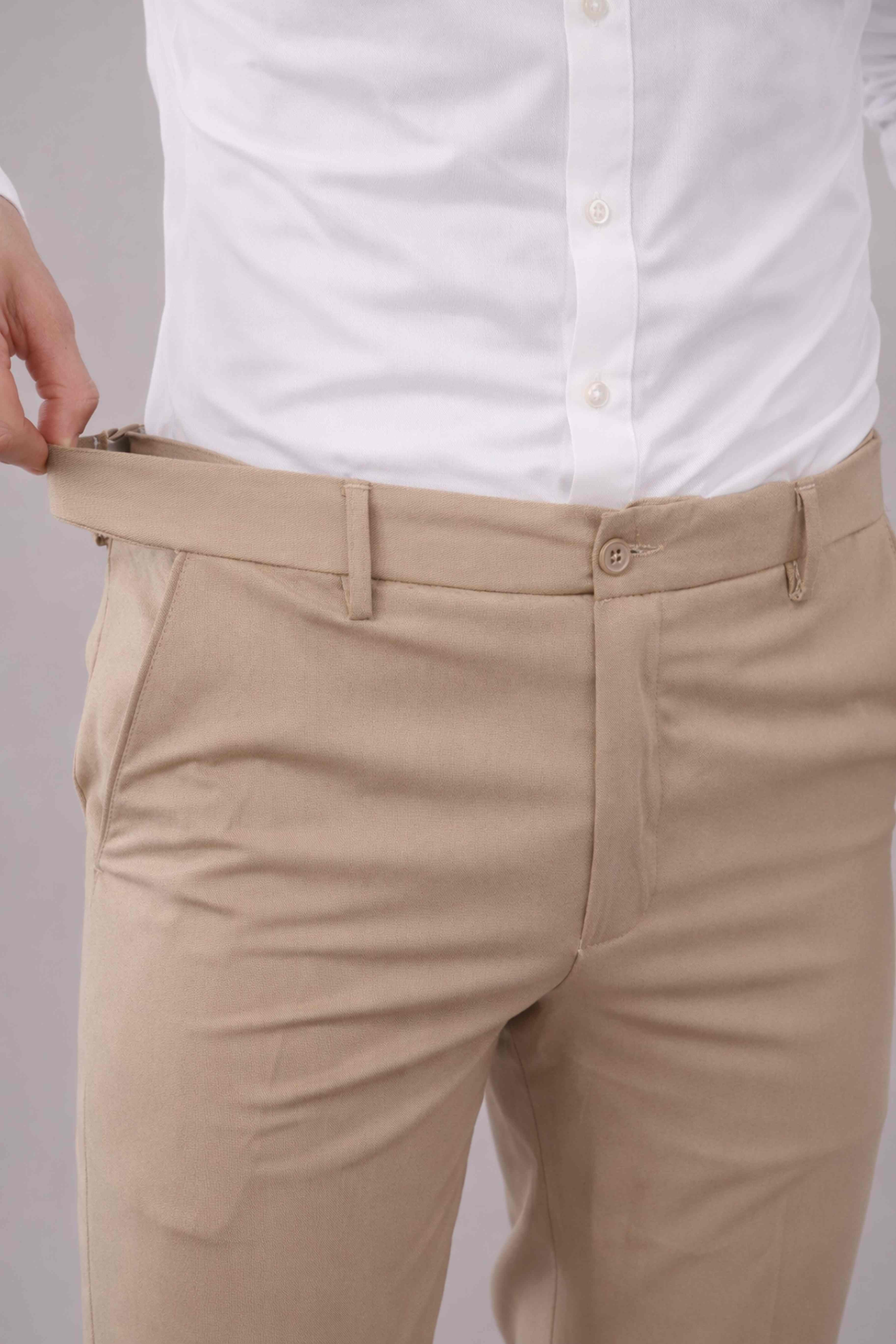 Beige pants being adjusted with a white shirt